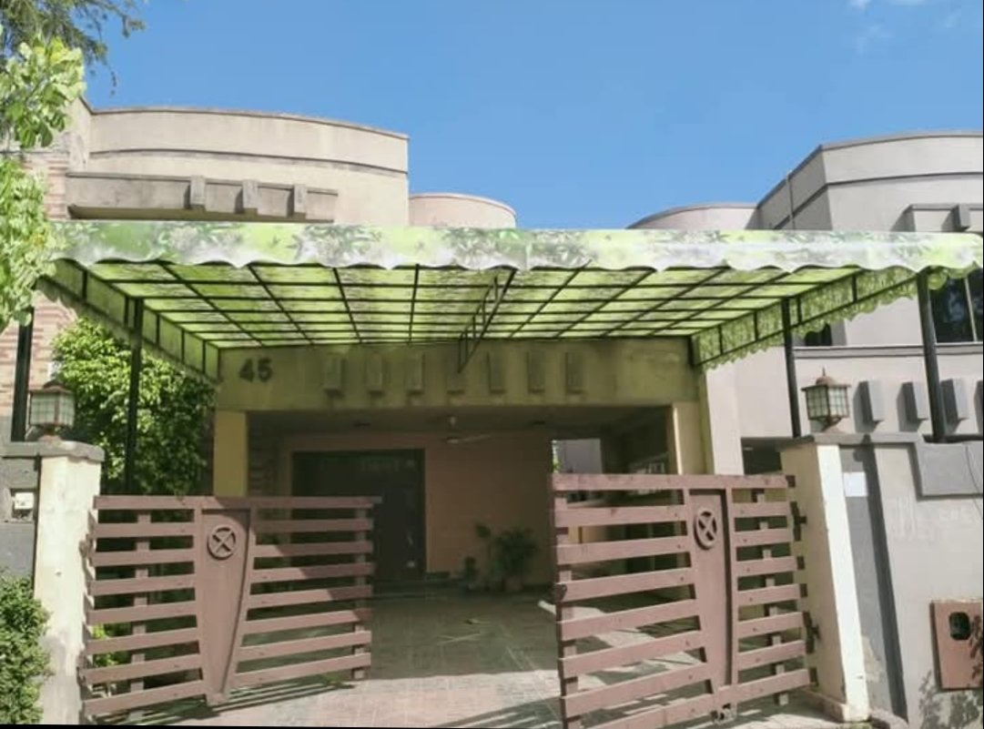 MKG Group fiberglass car shade installed over a residential driveway