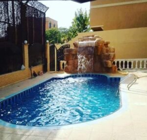 MKG Group Fiberglass Abshaar Stones – Rock waterfall feature beside a swimming pool