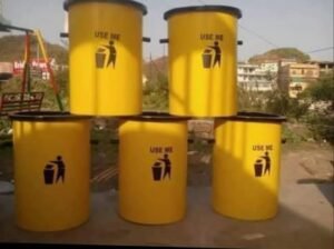 Yellow fiberglass waste bins with black lids and litter symbols