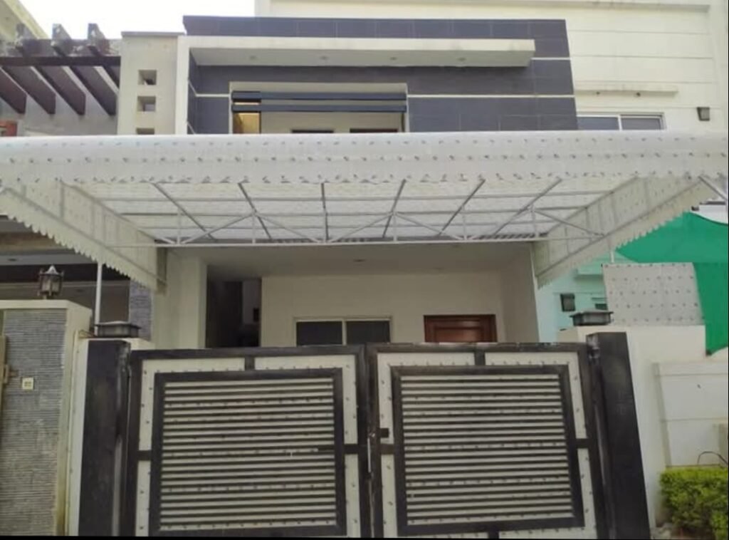 White covered car porch canopy over a residential entrance and gate