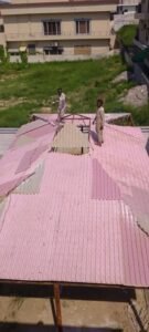 Fiberglass car shade roofing sheets and supporting structure during installation