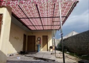 Floral-patterned canopy fitted over an outdoor residential area