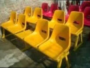 Yellow molded chairs displayed in a group
