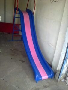 Fiberglass children’s park slide in blue and pink with a metal ladder