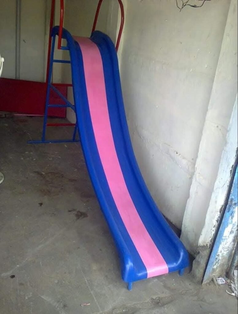 Fiberglass children’s park slide in blue and pink with a metal ladder