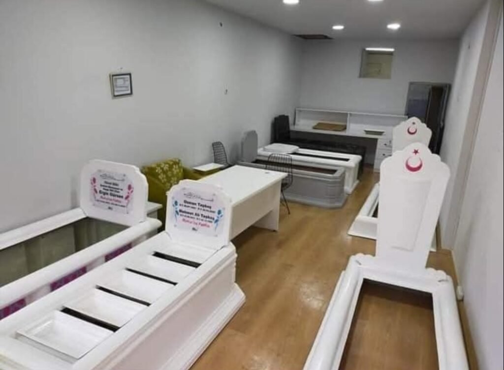 Fiberglass grave structures displayed in a workshop