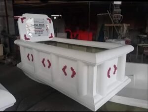 White moulded fiberglass grave structure with decorative details