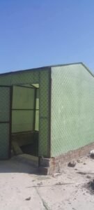 Fiberglass cabin with an entrance and patterned green wall panels